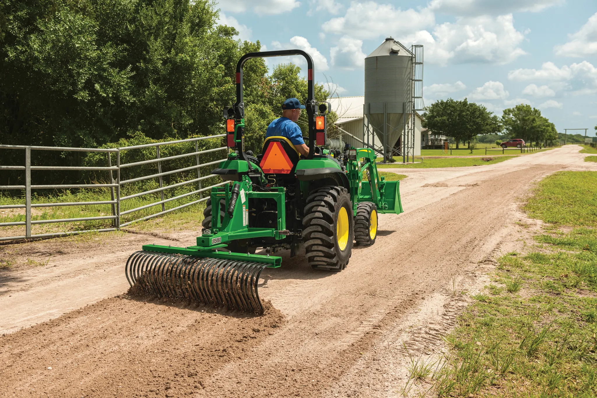 Raking dirt driveway with a 2032R Tractor using a LR5060 Landscape Rake