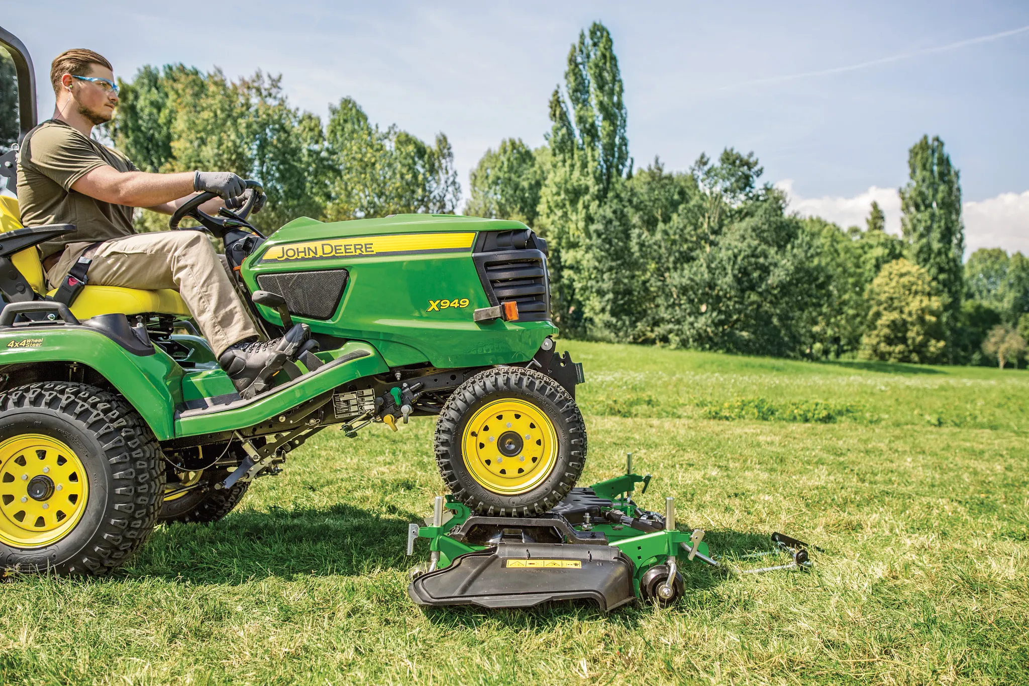 Man drives the X949 onto the Drive Over Deck in the field