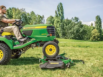 Man drives the X949 onto the Drive Over Deck in the field