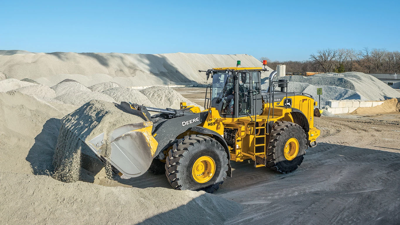 The John Deere 350 P-Tier Excavator skillfully curled its bucket after efficiently filling up with rock.