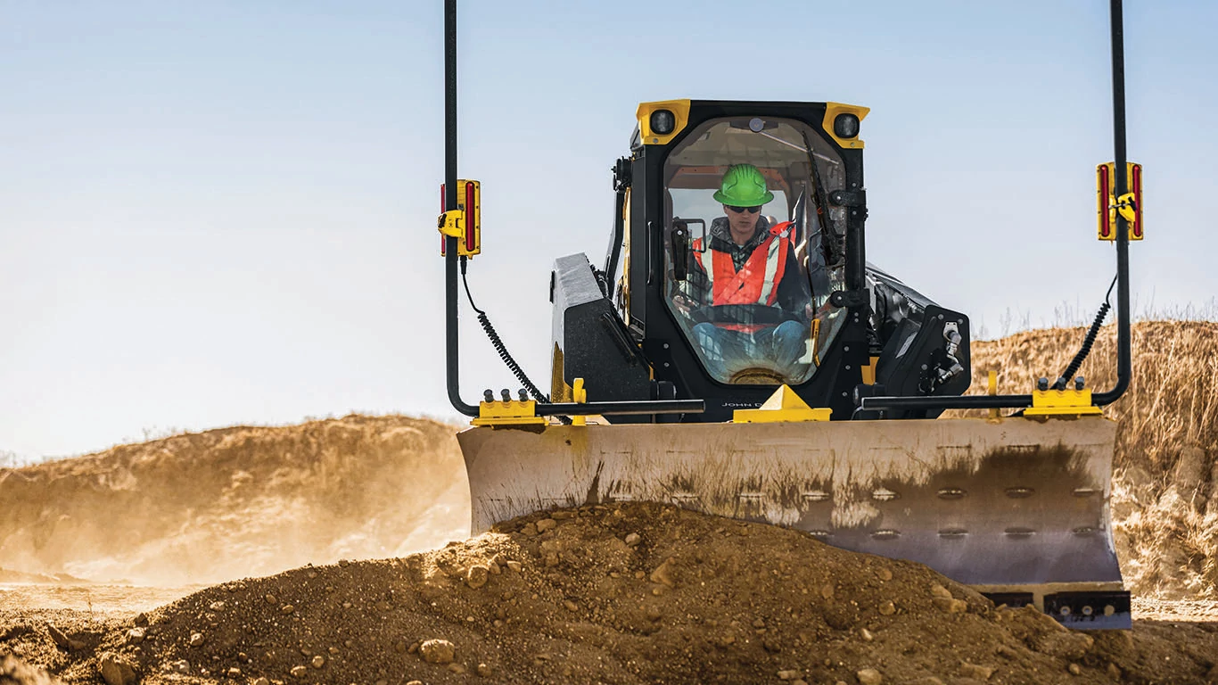 333 P-Tier compact track loader moving a large mound of dirt around a jobsite
