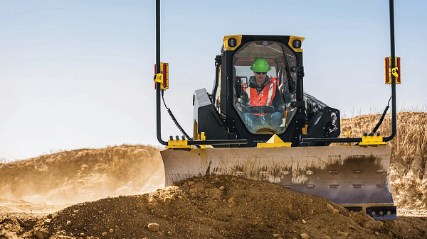 333 P-Tier compact track loader moving a large mound of dirt around a jobsite
