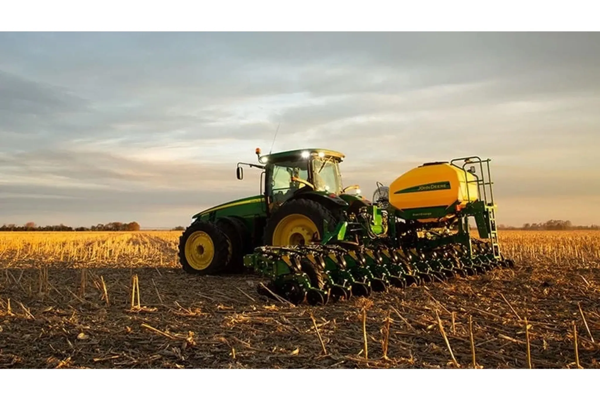 DR16 Planter pulled by a tractor in a field.