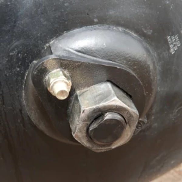 Close-up of an offset disk's end washer and nut, keeping gang tightened