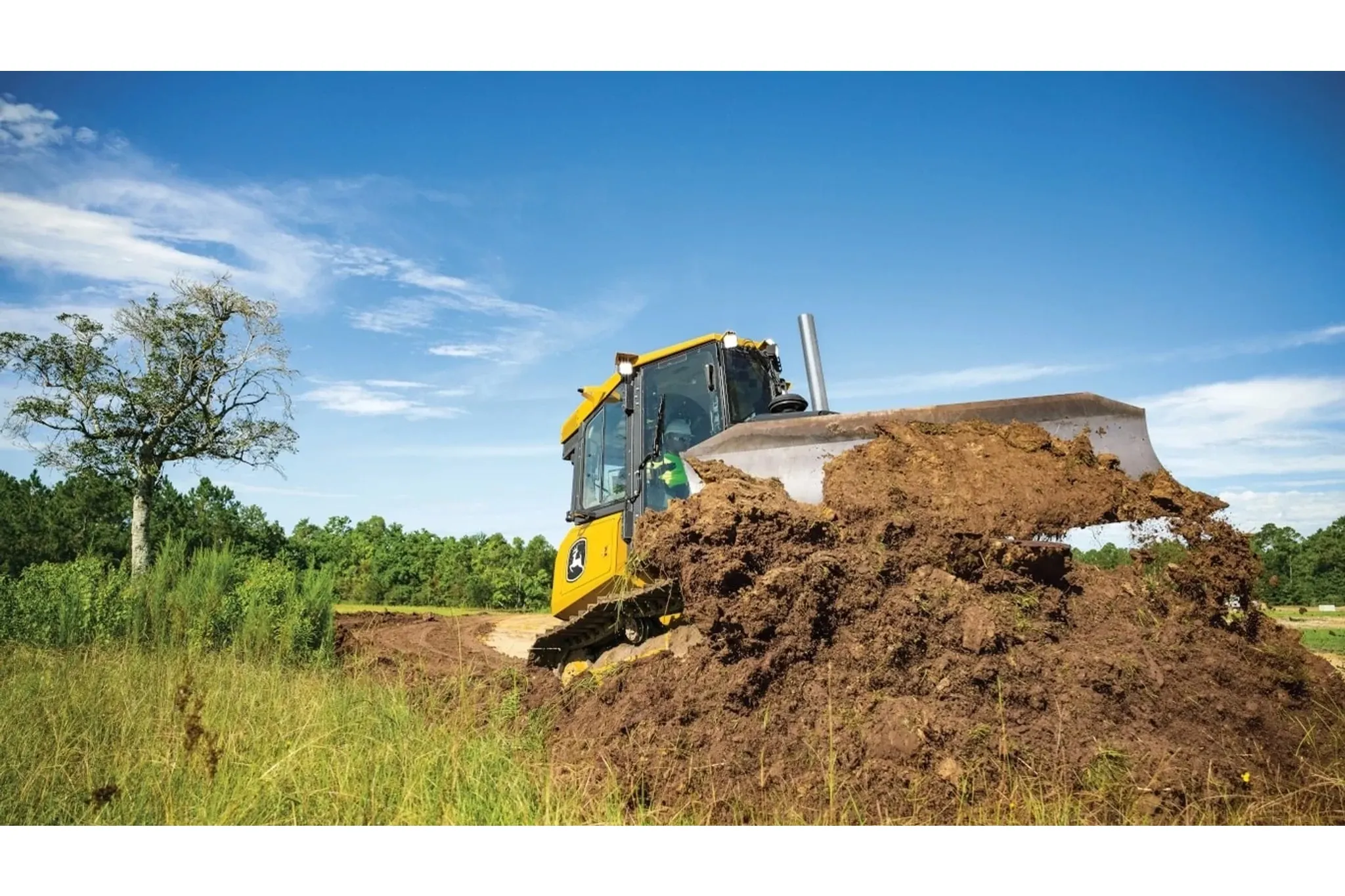 450 P-Tier scooping dirt in a field