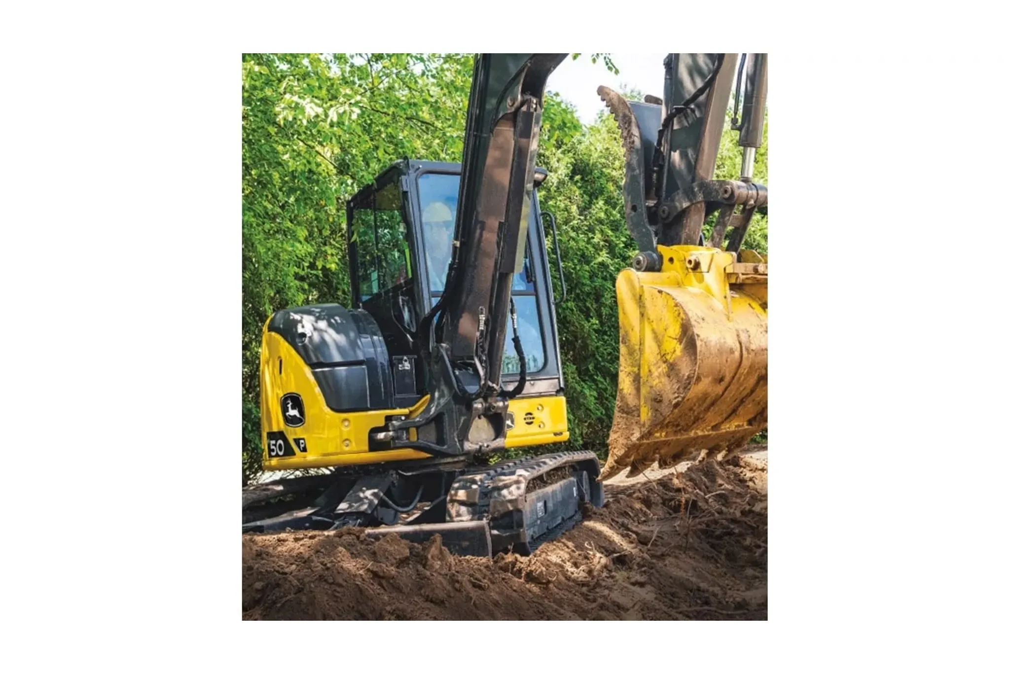 A 50P-Tier Excavator moving dirt with trees in the background