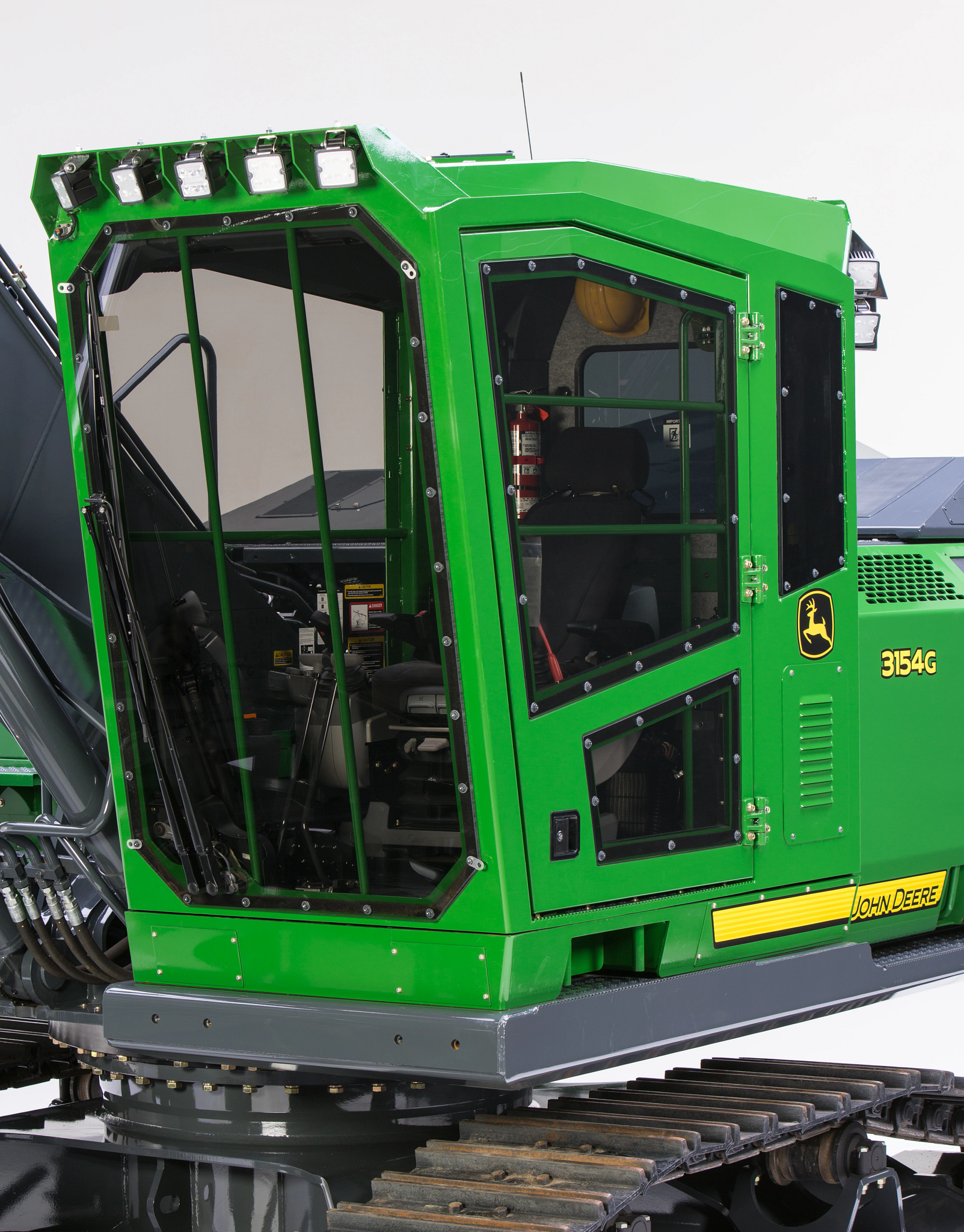 Forestry machine with an enclosed operator cab, protective window guards, rooftop work lights, and visible model marking “3154G".