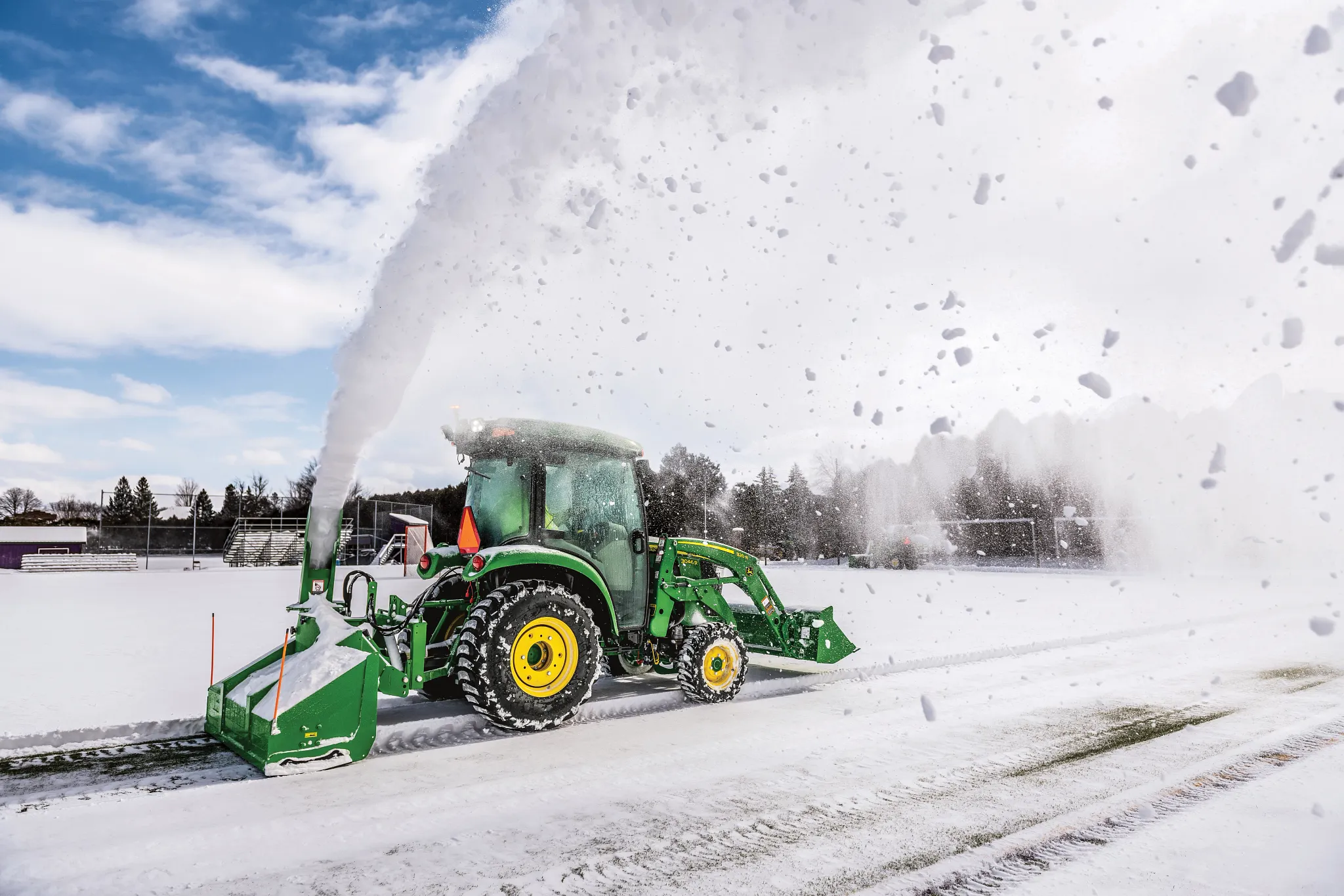 Blowing snow using a SB1164P Snowblower on 3046R Tractor in parking log