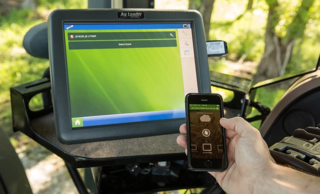 Mobile phone held next to in-cab display
