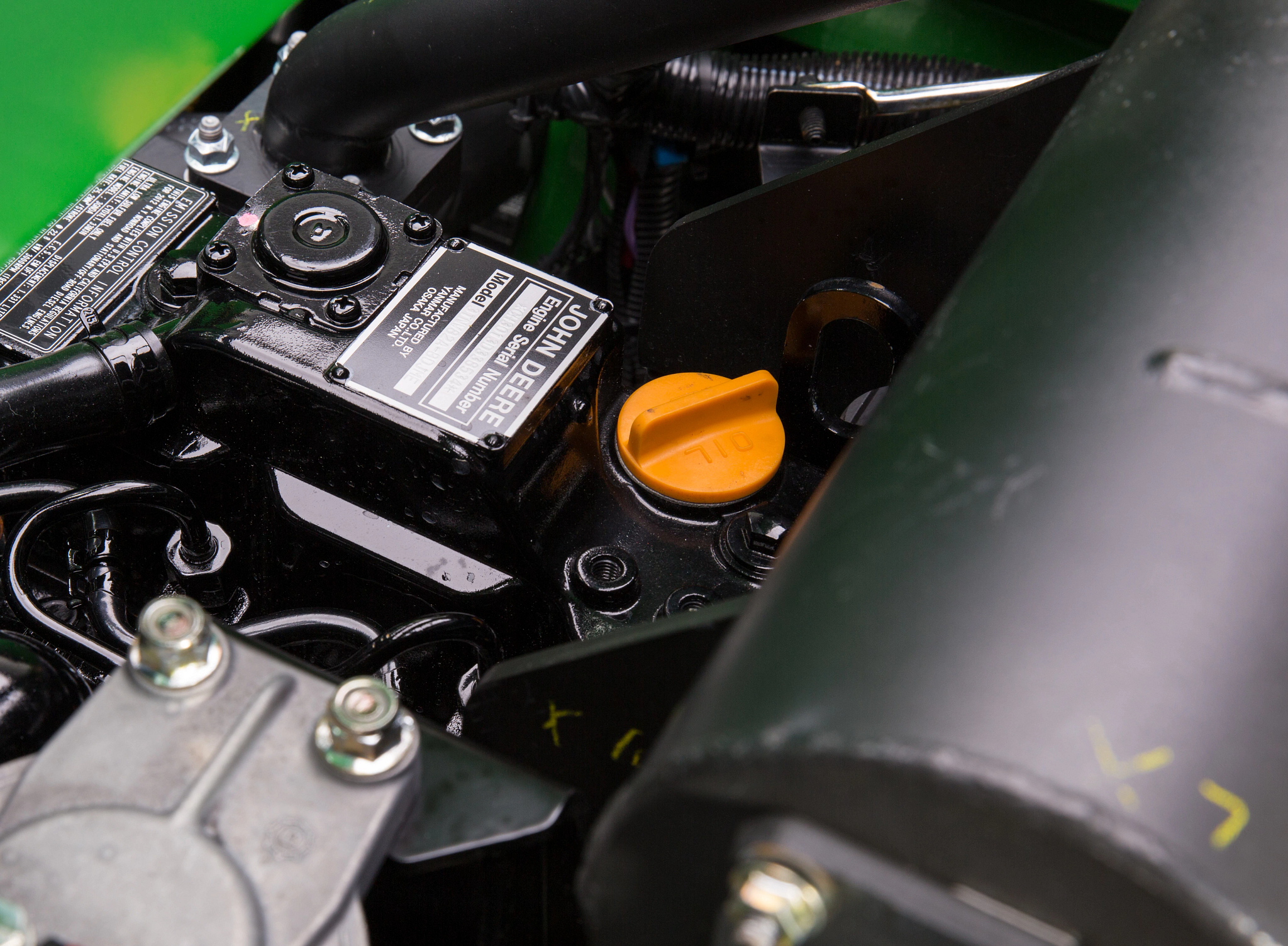 Close-up on three components of a 1570 TerrainCut™ Front Mower's diesel engine