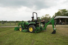 Side left view of an open operator's station 270B Backhoe on a lawn