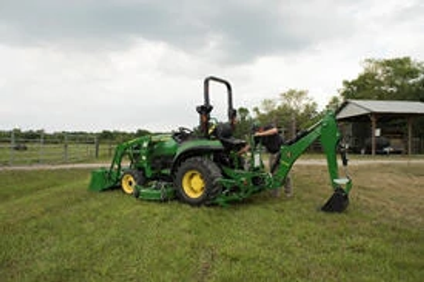 Side left view of an open operator's station 270B Backhoe on a lawn