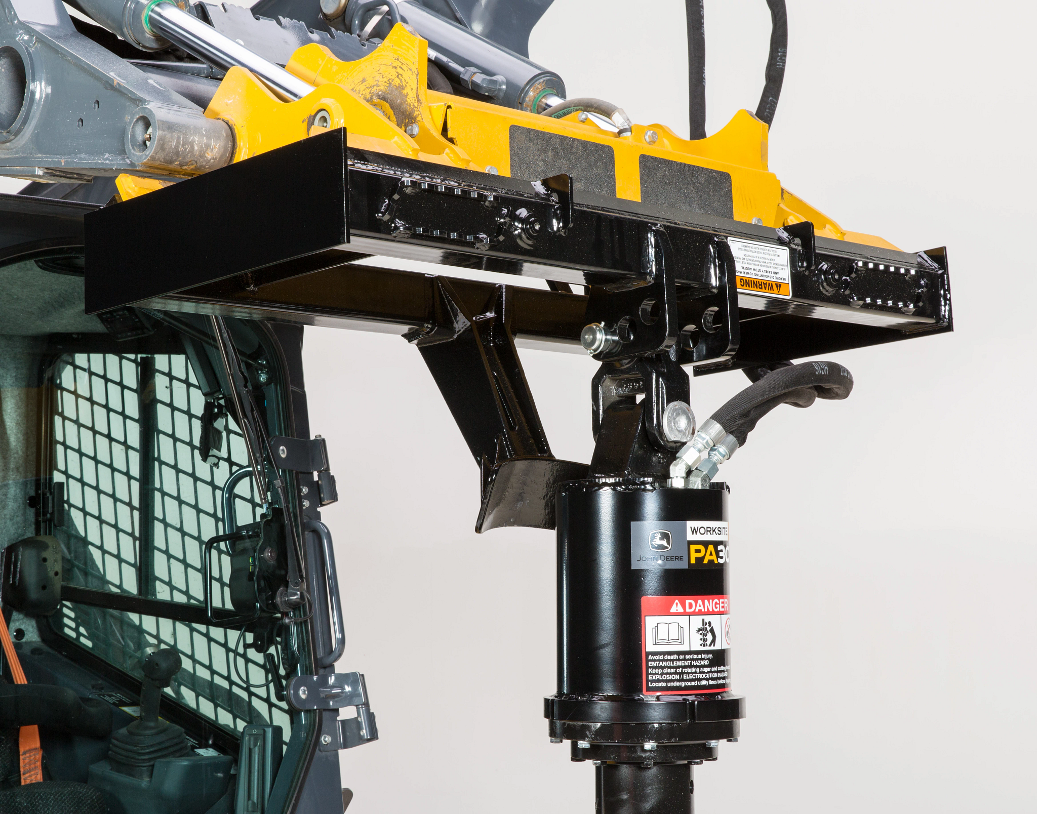 Front right close-up of a PA30B planetary auger's hydraulic motor and attachment site to a 331G compact track loader