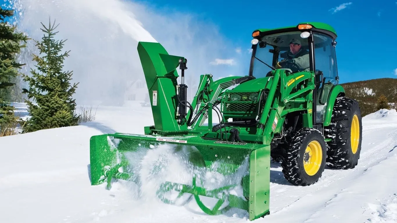 SB21 Snowblower attached to a tractor clearing snow
