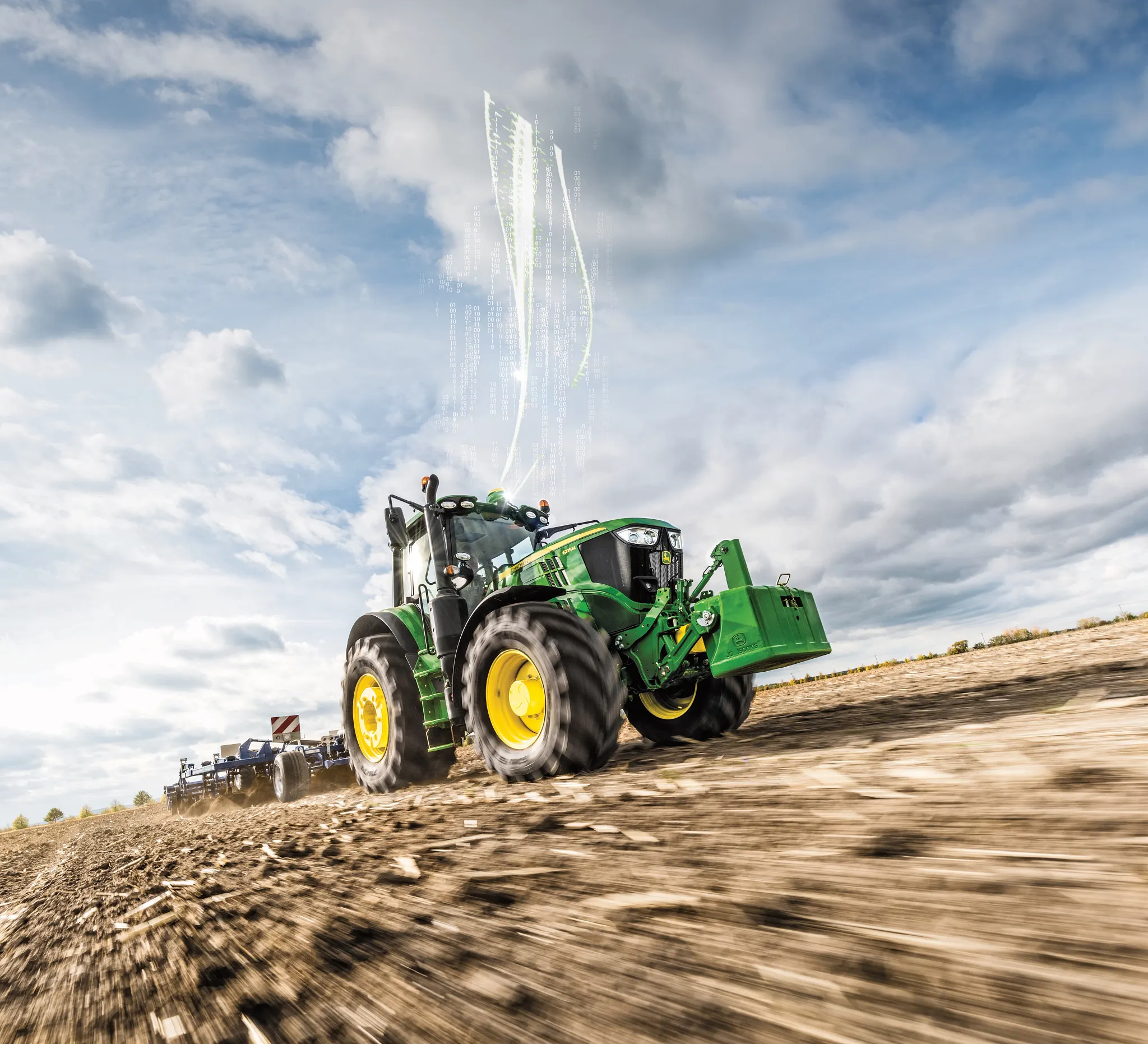 Right front view of a tractor pulling a tillage implement in a field