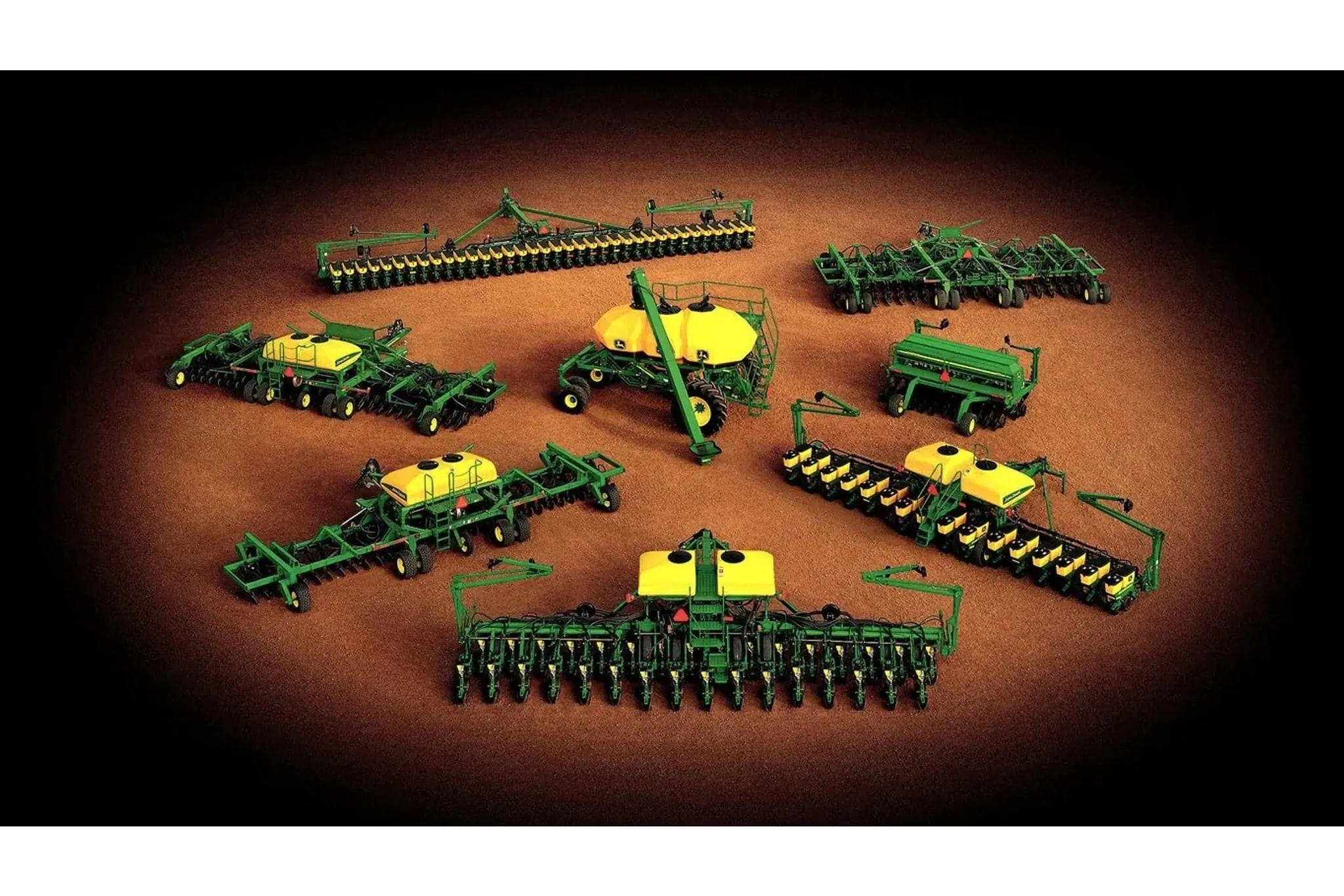 Eight John Deere planting and seeding machines on a brown and black background