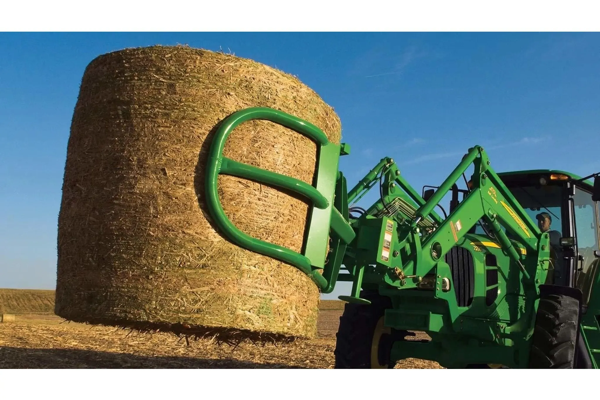 Front left view of AH11 Series Bale Hugger carrying a round bale in the field