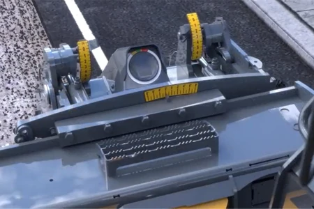 Close-up of the gauge and parameter tools on a cold planer, three yellow rulers installed atop it