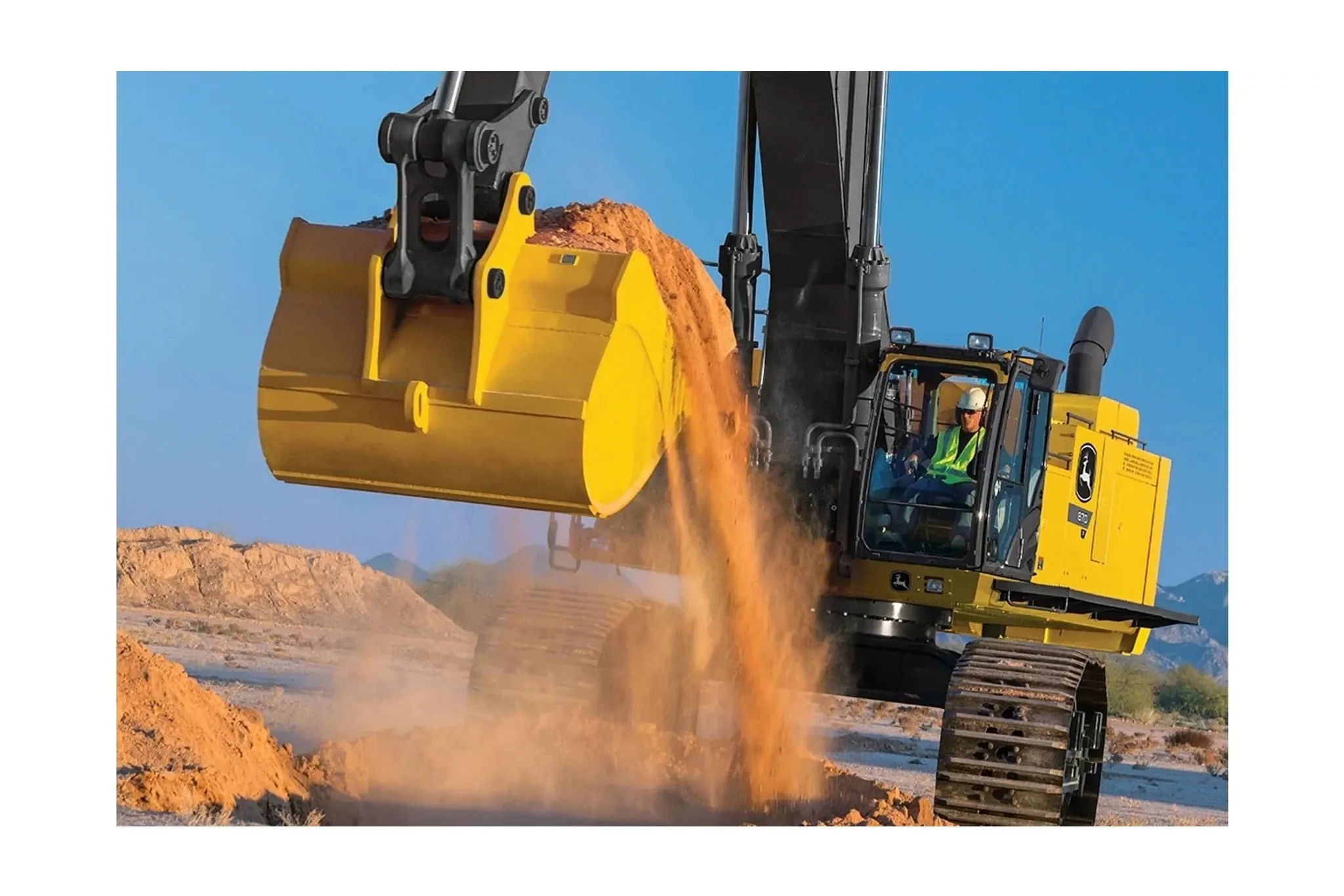 Construction worker with a bucket full of dirt in an 870 P-Tier Excavator