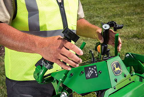 Closeup of a commercial operator's hands while mowing lawn