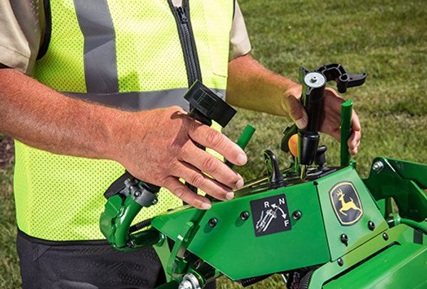 Closeup of a commercial operator's hands while mowing lawn