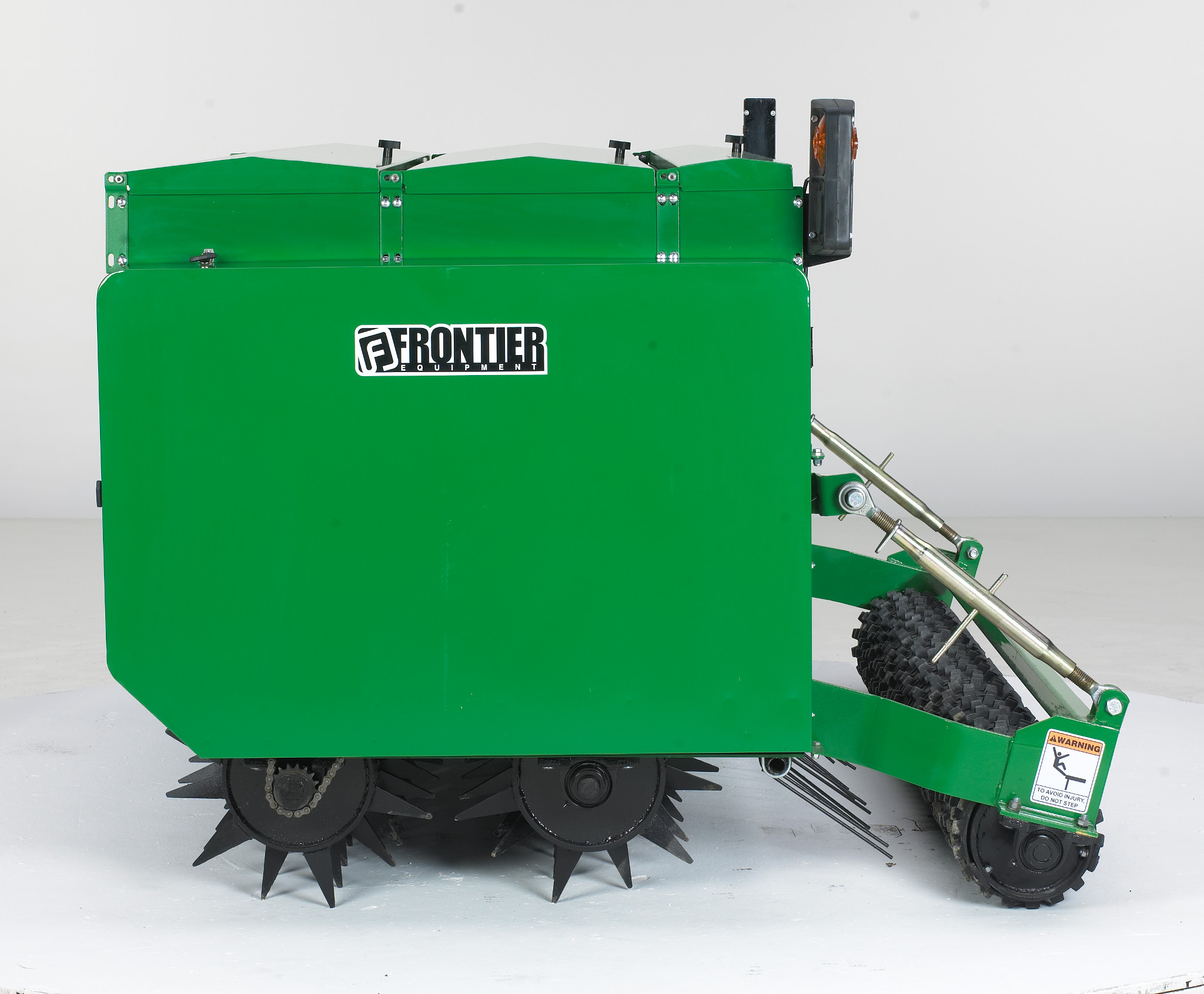Left side studio view of CS Conservation Seeder showing the seedbox, spiked rollers, and rear cultipacker