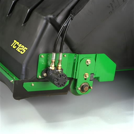 Close‑up of a green metal mounting bracket with hydraulic hoses, fittings, and a round adjustment knob attached to agricultural equipment housing.