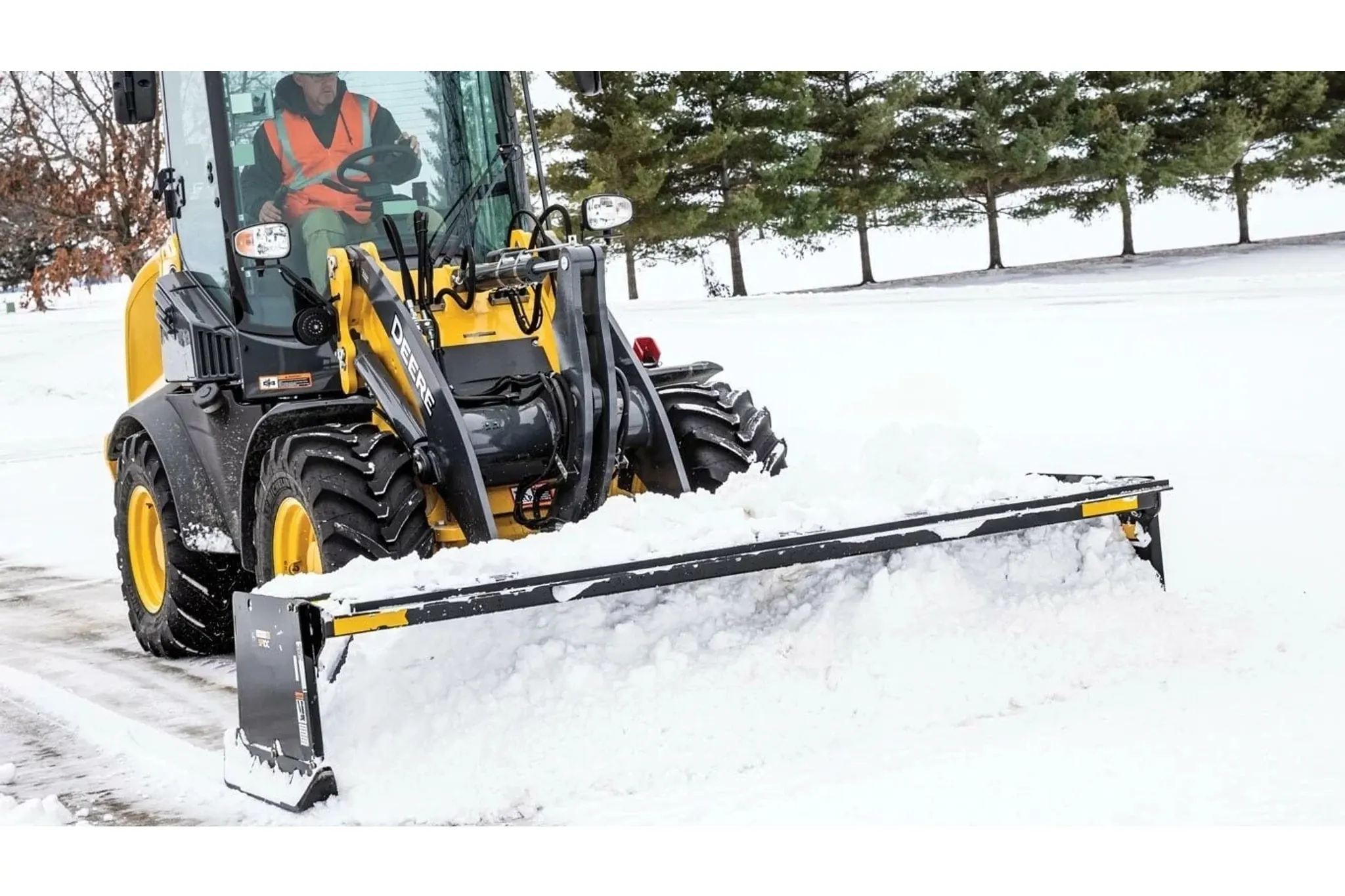 224L Wheel Loader with an SP10C Snow Pusher Attachment pushing snow in a parking lot