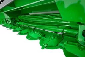 Front left close-up of a rotary platform's green oval disks with free-swinging knives