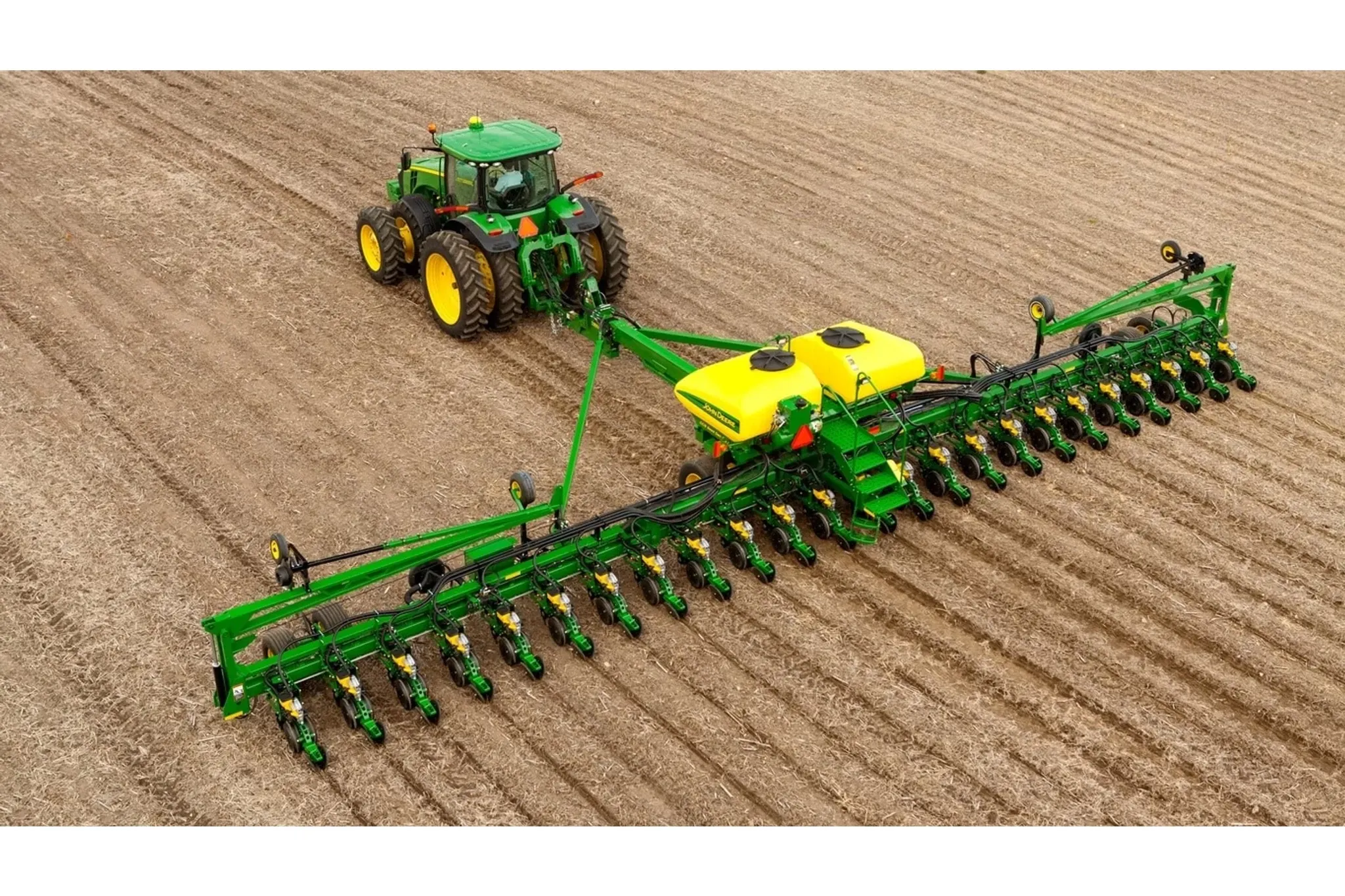 Overhead view of DB60 24Row30 Planter pulled through a field by a large tractor