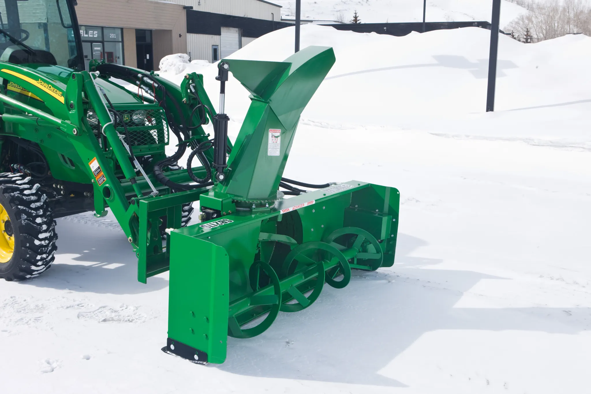 SB2176 Snowblower attached to a utility tractor sitting on a snowy drive