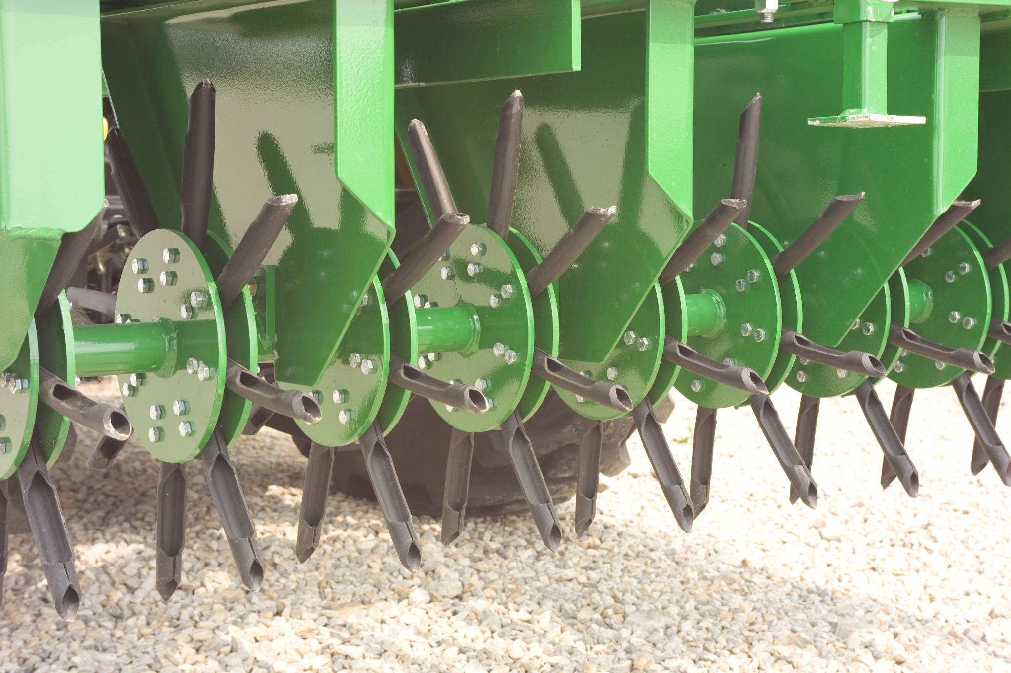 Close-up of aerating spoons and bronze bushings on the CA20E Core Aerator
