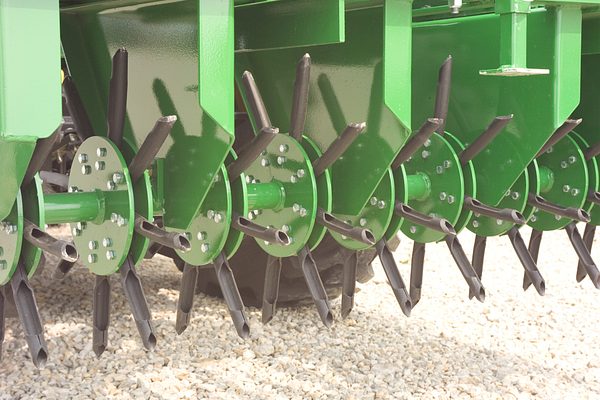 Close-up of aerating spoons and bronze bushings on the CA20E Core Aerator