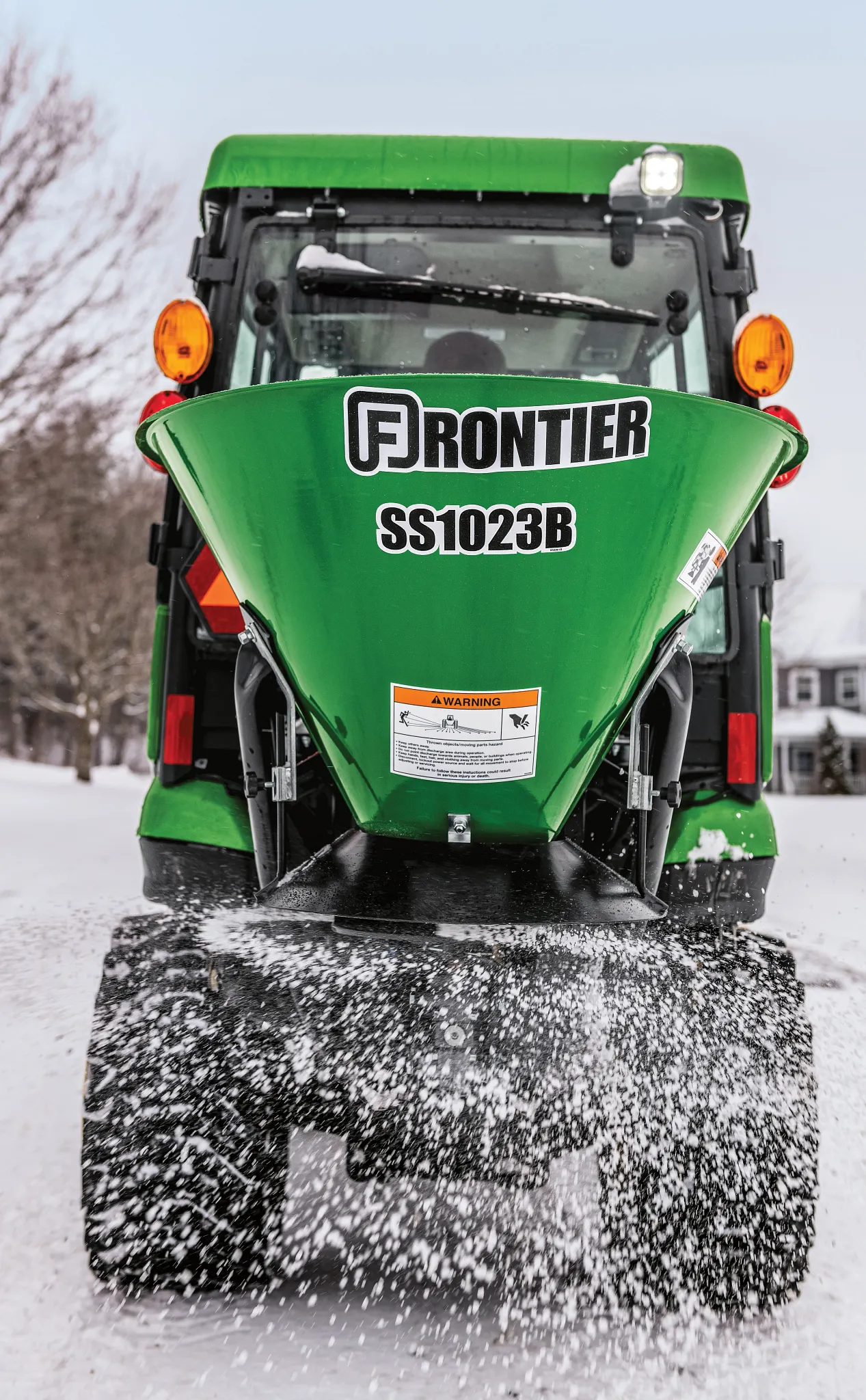 SS1023B spreading salt in snowy drive