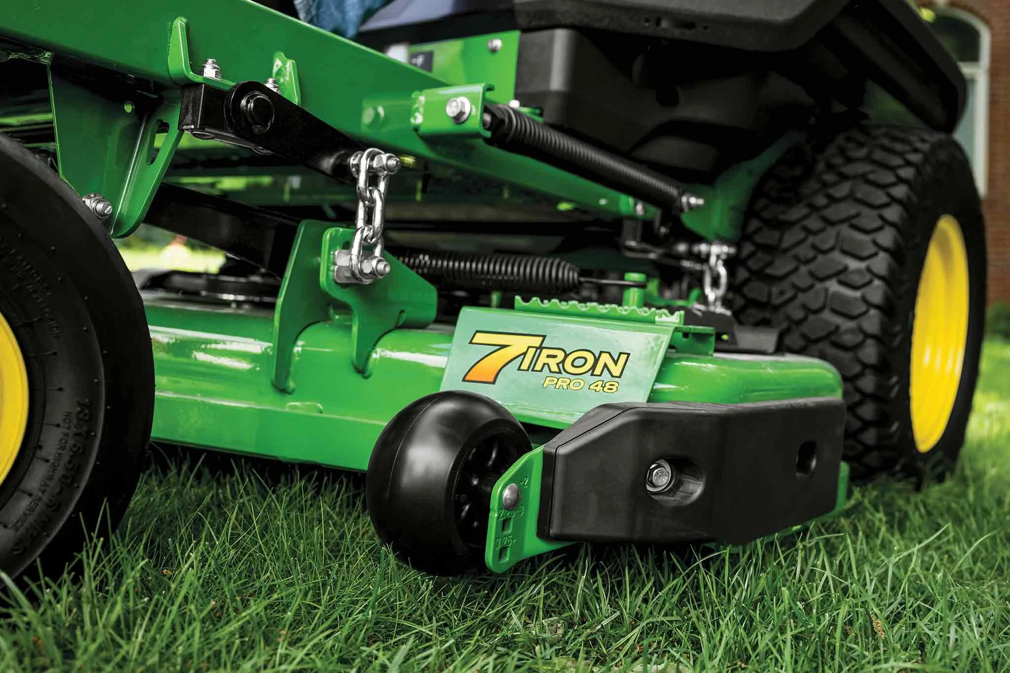 A zoomed-in shot of a green 7Iron PRO 48 inch deck on grass.
