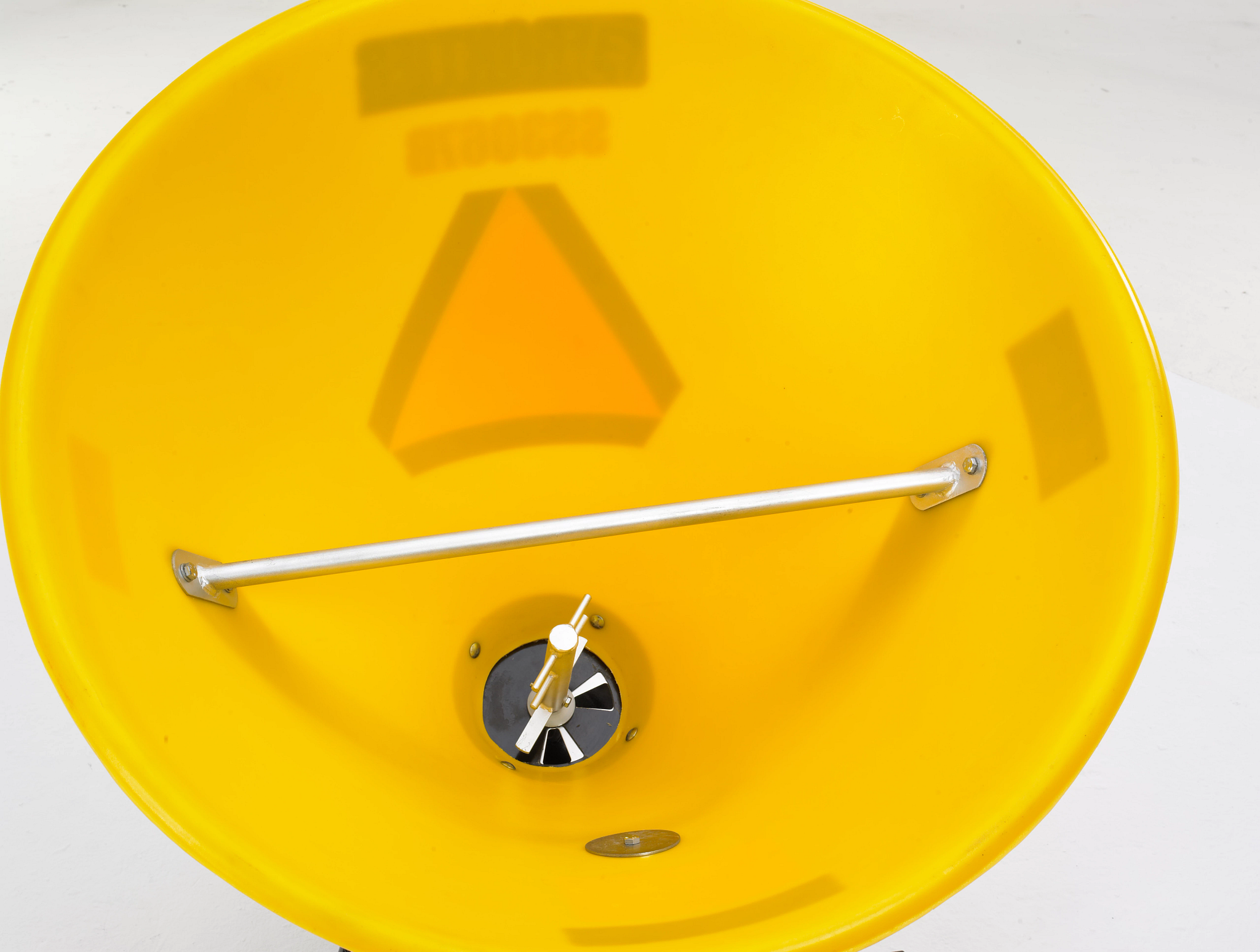 Top, studio view of an SS3067B broadcast spreader's yellow polyethylene hopper