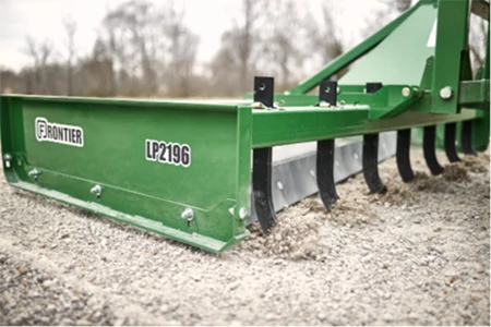 Front right view of a LP2196 land plane resting on gravel with scarifier shanks on display