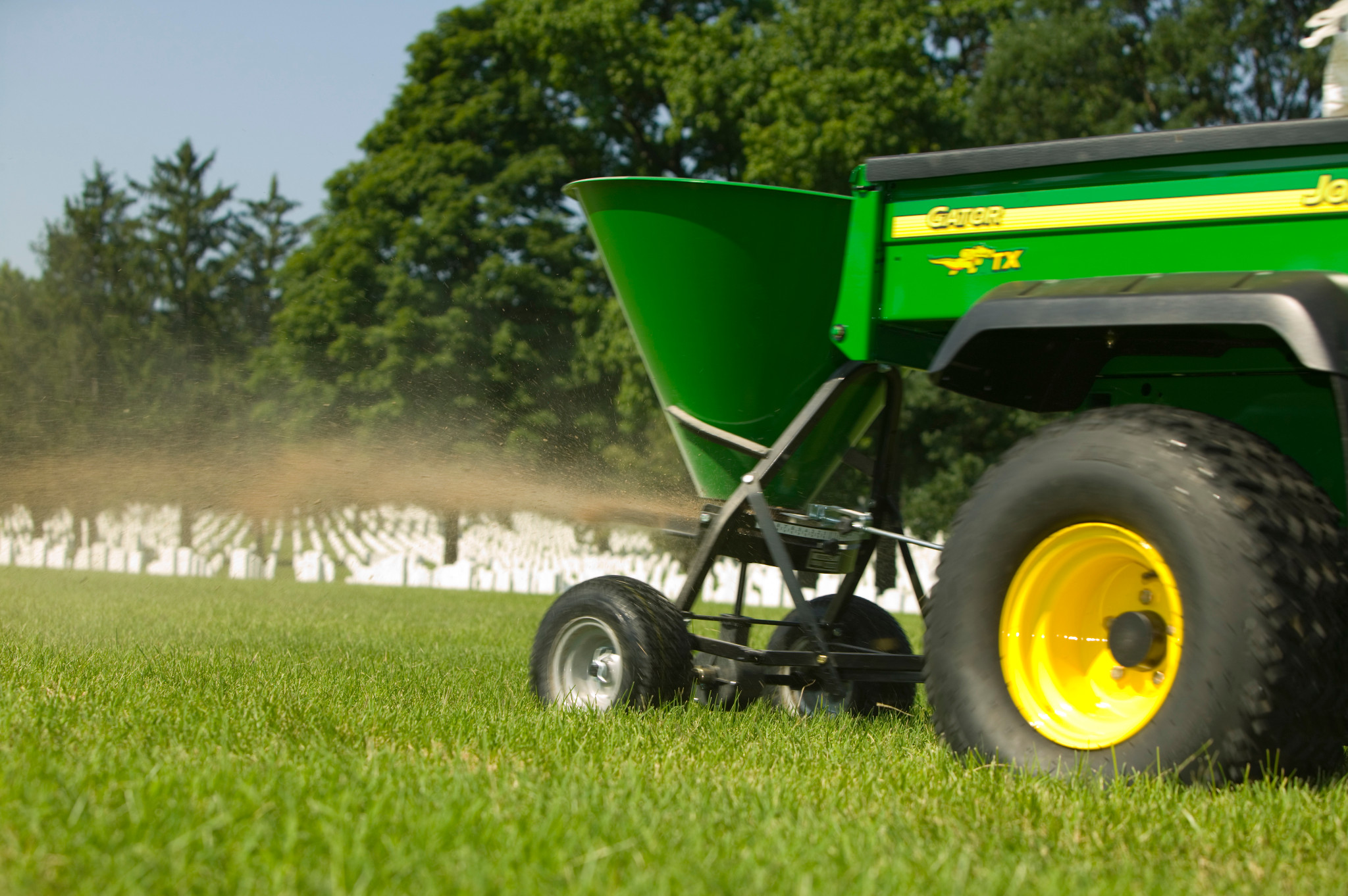 Field view of SS1022B spreader on Gator in grass