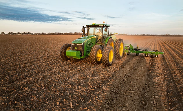 Tractor pulls implement through field