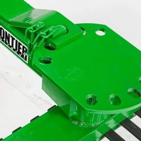 Close-up of agricultural attachment showing a reinforced mounting plate with bolt holes, hinge hardware, and part of the brand name “Frontier”.
