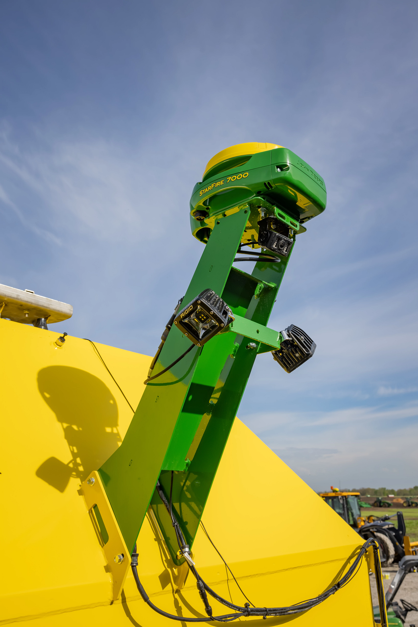 Close-up of the yellow rear of an ST16 Drawn 40-ft strip till with StarFire 7000 mounted on green post with two square cameras