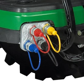 Close-up of red, yellow, black, and blue plugs on the corner of a machine, near a tire
