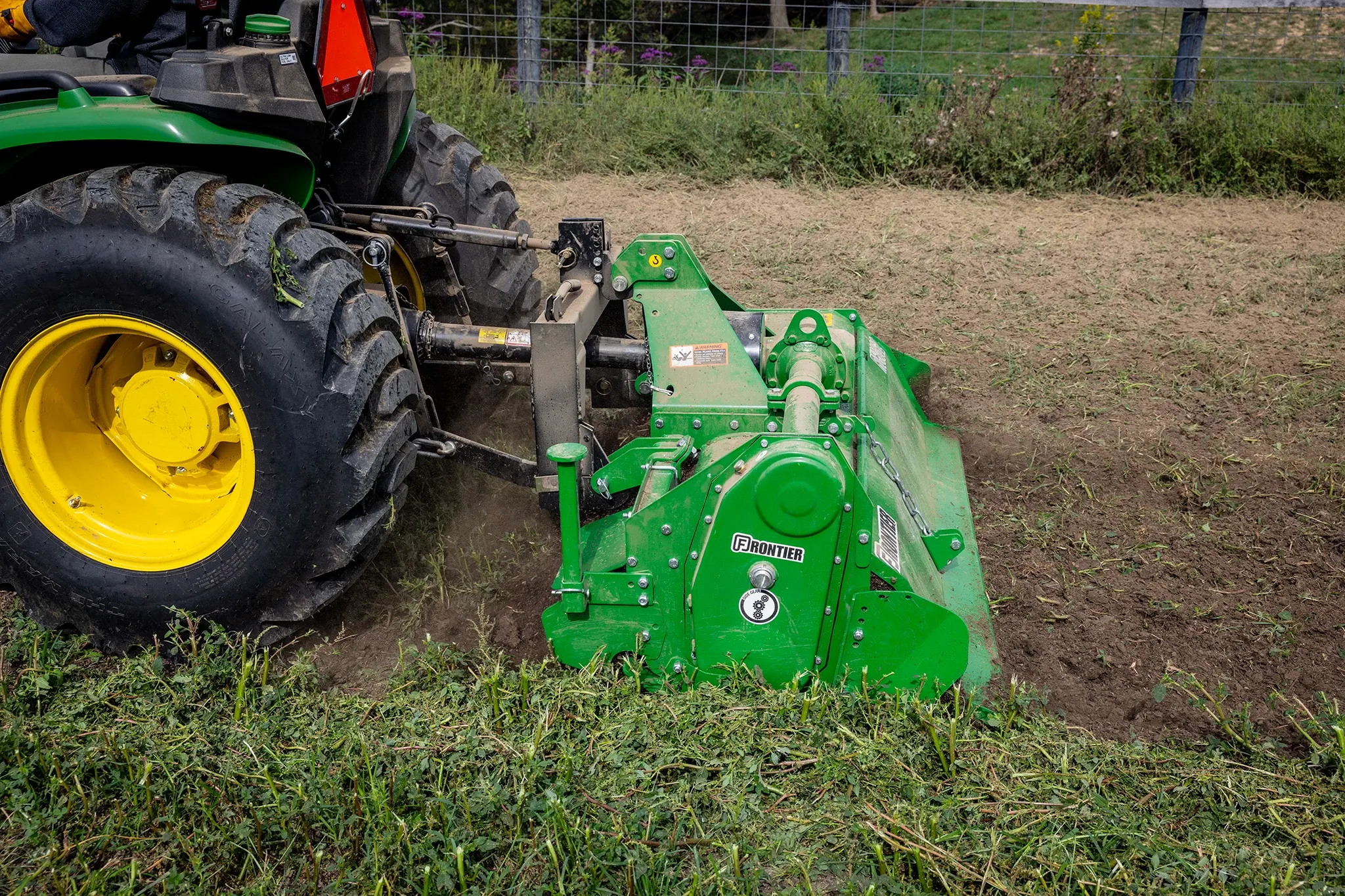 RT3062 Rotary Tiller working up dirt in a field