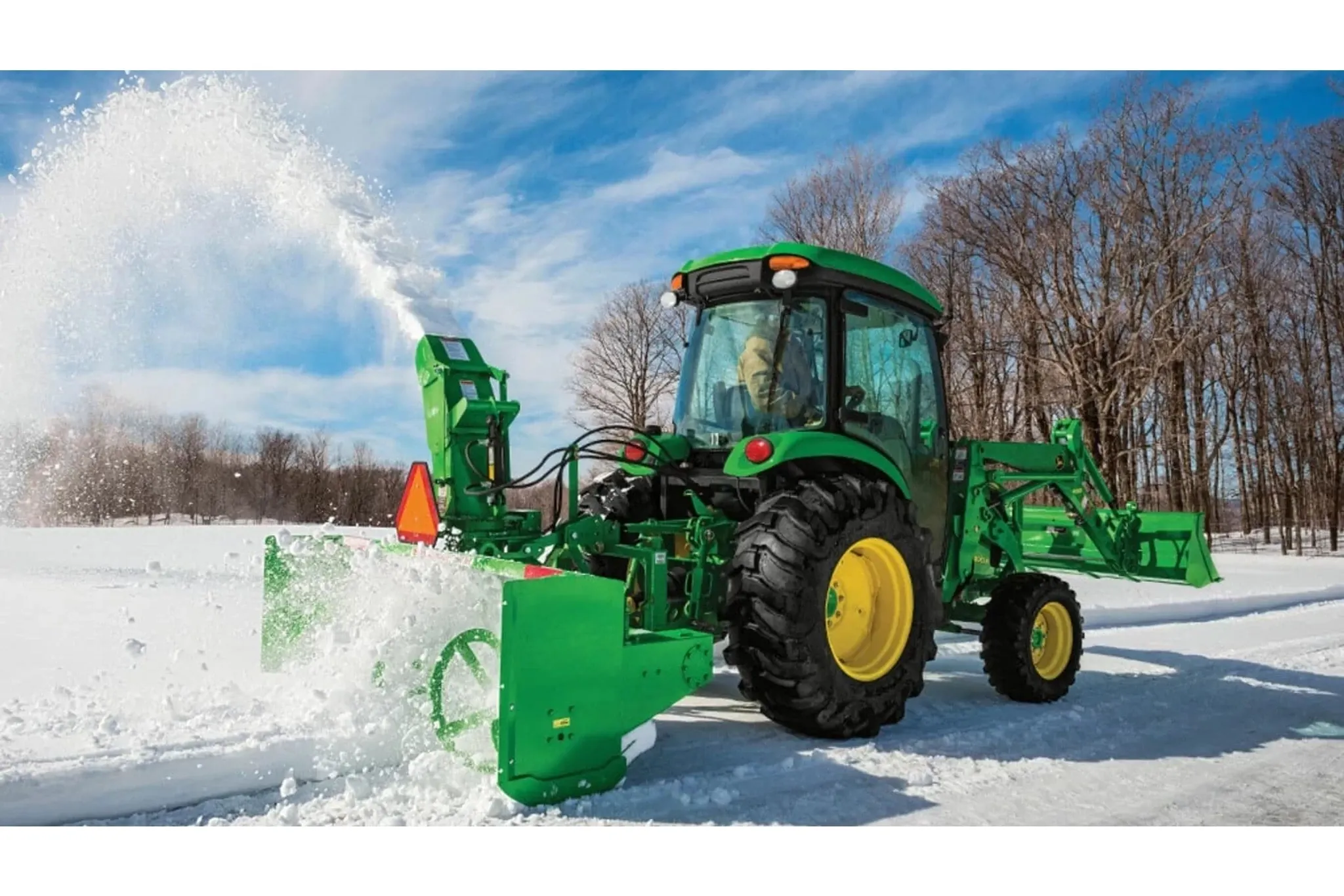 A person clearing snow with a 4052R Compact Tractor attachment