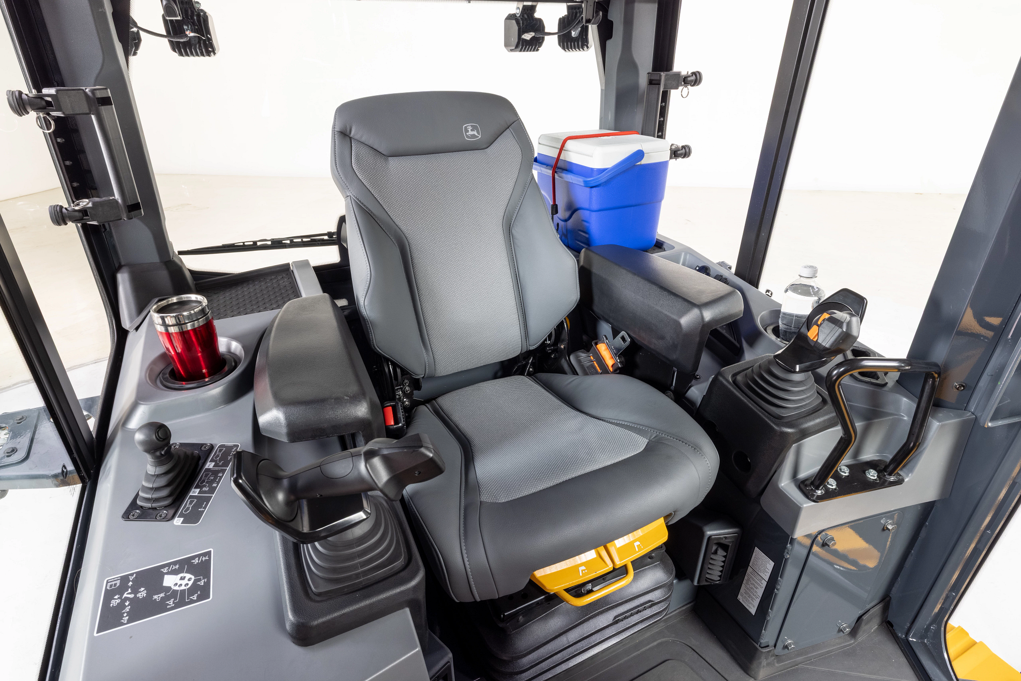 Front right view of a 650 P-Tier Dozer's interior operator station: controls, seat, wide windows
