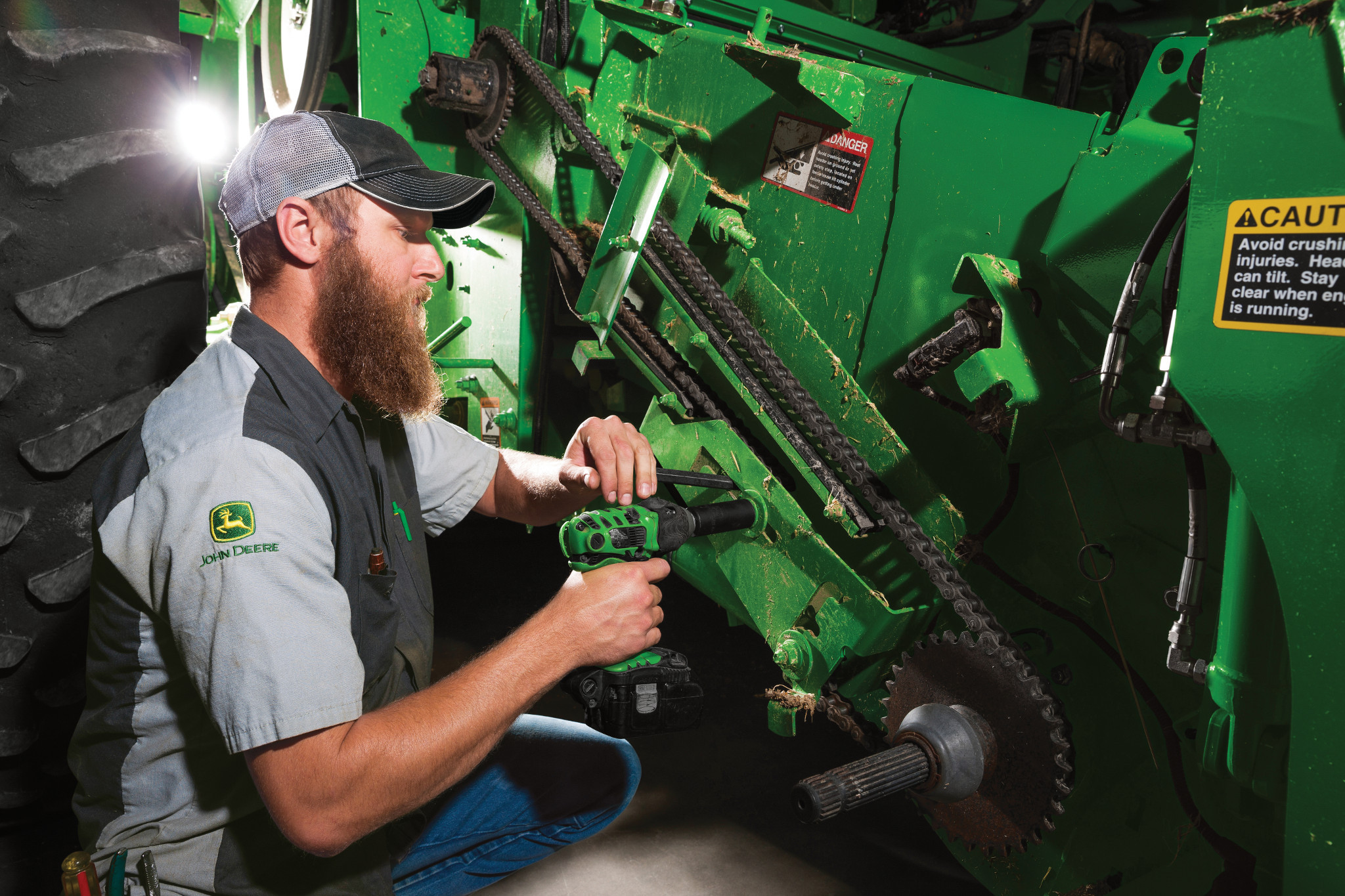 John Deere technician inspecting an S670 combine