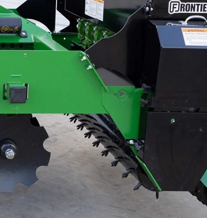 Side view of a GS41 Ground Seeder's Spiked Drive Roller and notched disc blades.