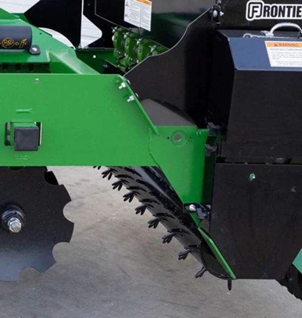 Side view of a GS41 Ground Seeder's Spiked Drive Roller and notched disc blades.